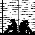 Migrant refugees behind barbed wire, silhouette of a pair of sad