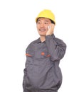 Migrant worker wearing yellow hard hat in front of white background is calling home Royalty Free Stock Photo