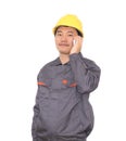 Migrant worker wearing yellow hard hat in front of white background is calling home Royalty Free Stock Photo