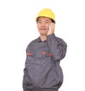 Migrant worker wearing yellow hard hat in front of white background is calling home Royalty Free Stock Photo