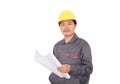 Migrant worker wearing yellow hard hat holding drawings in hand in front of white background Royalty Free Stock Photo