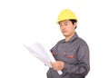 Migrant worker wearing yellow hard hat holding drawings in hand in front of white background Royalty Free Stock Photo