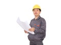 Migrant worker wearing yellow hard hat holding drawings in hand in front of white background Royalty Free Stock Photo