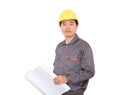 Migrant worker wearing yellow hard hat holding drawings in hand in front of white background Royalty Free Stock Photo