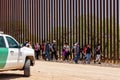 Migrants Crossing Through Border Fence from Mexico