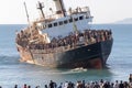 Migrants in an overcrowded boat cross the sea
