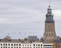 Migrating birds passing middle aged European city