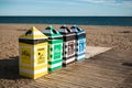 Colorful recycling trash cans on a Spanish beach.