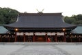 Miko or priestess of Kashihara Jingu Temple lighted by lanterns in Nara