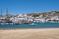 Mikonos island, Cyclades, Greece. Mykonos port moored boat, building, blue sky background Royalty Free Stock Photo