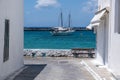 Mikonos island, Cyclades, Greece. View of moored boat between Mykonos building, blue sky background Royalty Free Stock Photo