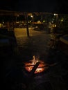 Mikumi, Tanzania - December 5, 2019: a small bonfire with a soft flame in the evening at the lobby of the African lodge. Vertical