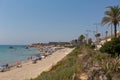 Mil Palmeras beach Costa Blanca Spain with palm trees and holidaymakers with parasols in beautiful summer weather