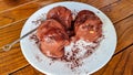 Milan - Chocolate Profiterole. Sweet dessert on white plate. Homemade profiteroles with cream