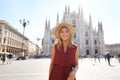 Milan fashion. Young chic woman walking in main square smiling on sunny day