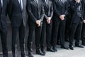 Bodyguards in black suit before Giorgio Armani fashion show, Milan Fashion Week street style on February 27, Royalty Free Stock Photo