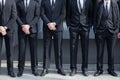 Bodyguards in black suit before Giorgio Armani fashion show, Milan Fashion Week street style on February 27, Royalty Free Stock Photo