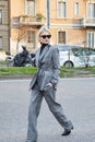 Caroline Daur with gray jacket and trousers walking before Alberta Ferretti fashion show, Milan Fashion Week