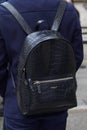 Man with black crocodile leather Marciano backpack before Max Mara fashion show, Milan Fashion Week street