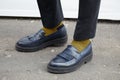 Man with blue leather shoes and yellow and black striped socks before fashion Albino Teodoro show, Milan