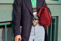 Man with Gucci belt with Tiger head and red and black checkered bag before Gucci fashion show, Milan Fashion