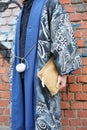 Man poses for photographers with blue kimono with intricate design before Fendi fashion show, Milan Fashion