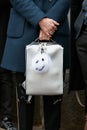 Man poses for photographers with silver backpack and Fendi fur before Fendi fashion show, Milan Fashion Week