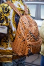 Man with Versace shirt and MCM brown leather backpack with studs before Tod`s fashion show, Milan Fashion