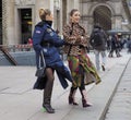 MILAN - FEBRUARY 25, 2018: Two fashionable women posing for photograpers in Duomo square after STELLA JEAN fashion show.