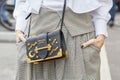 Woman with black leather Prada bag with golden moon and stars decoration white shirt before fashion Albino