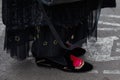 Woman with black velvet shoes with red heart and long skirt before fashion Albino Teodoro show, Milan Fashion