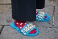 Woman with blue furry sleepers decorated with pearls before Bottega Veneta fashion show, Milan Fashion Week