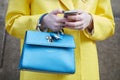 Woman with blue Gianfranco Lotti bag and yellow coat before Ermanno Scervino fashion show, Milan Fashion Week Royalty Free Stock Photo