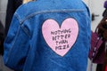 Woman with blue jeans jacket with pink heart with `Nothing better than pizza` motto before fashion Albino