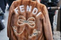 Woman with brown fur jacket with pearls decoration before Fendi fashion show, Milan Fashion Week street style