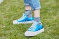 Woman with Converse All Stars iridescent blue shoes before Emporio Armani fashion show, Milan Fashion Week