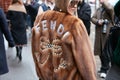 Woman with Fendi brown fur coat with pearls decoration before Fendi fashion show, Milan Fashion Week street