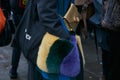 Woman with golden bag and yellow, green and purple fur pockets before Fendi fashion show, Milan Fashion Week