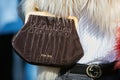 Woman with Miu Miu brown velvet bag and Gucci belt before Giorgio Armani fashion show, Milan Fashion Week