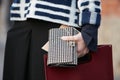 Woman poses for photographers with black and white pochette before Blugirl fashion show, Milan Fashion Week