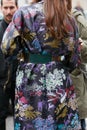 Woman poses for photographers with coat with intricate floral design before Etro and Iceberg fashion show,