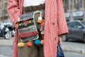 Woman poses for photographers with gipsy decorated belt before Gucci fashion show, Milan Fashion Week Day 1