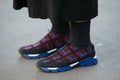 Woman poses for photographers with technical neoprene shoes before Blugirl fashion show, Milan Fashion Week