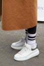 Woman with white and silver sneakers shoes and beige coat before fashion Albino Teodoro show, Milan Fashion