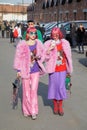 Women with pink hair and fur coat walking before Gucci fashion show, Milan Fashion Week street style on