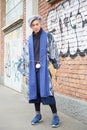 Young man with white hair poses for photographers in blue kimono before Fendi fashion show, Milan Fashion