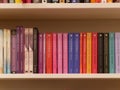Milan, italy - August 2018: colorful books aligned on bookshelf