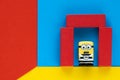 Milan, Italy - August 11 2019: Minion toy in prisoner`s clothes inside prison with shocked expression on multicoloured paper