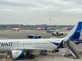 Milan, Italy - 17 august 2023: Passenger plane with covered airstairs stands on the runway Royalty Free Stock Photo