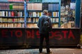 A man looks curious about the titles of the books